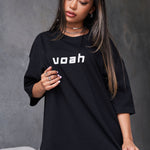 black oversized tee with the brand name 'voah' printed on the front and a paint splatter graphic design on the back.